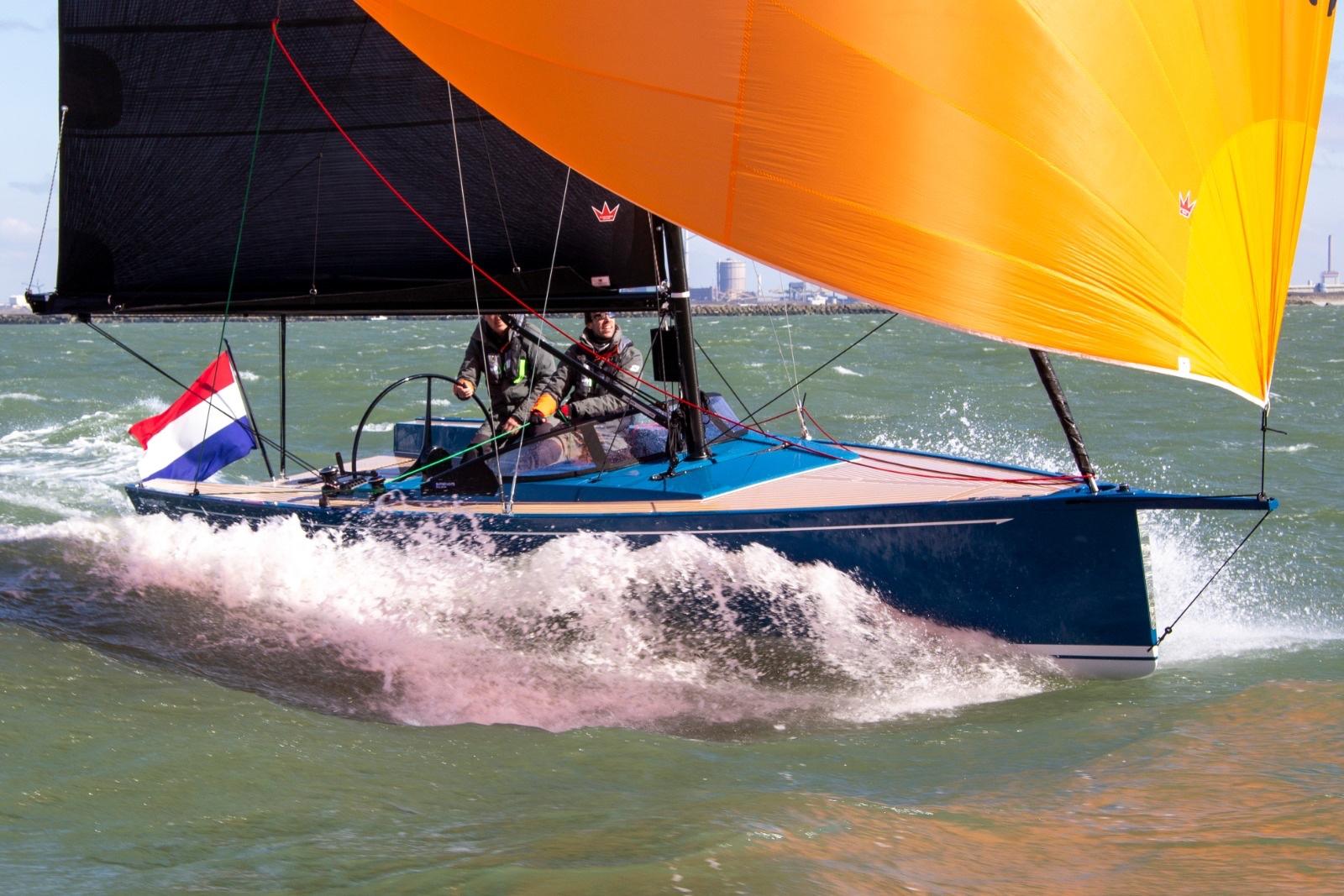 Saffier Se 27 Leisure 2026 sailboat with vibrant orange sail on open water.