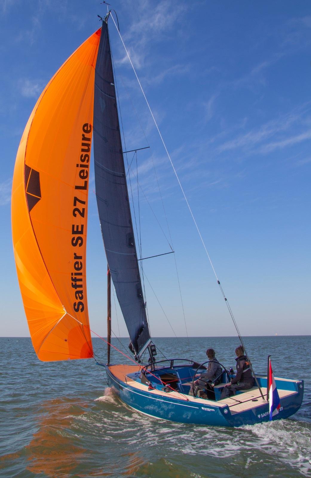 Saffier Se 27 Leisure sailboat, 2026 model, with vibrant orange sail on open water.