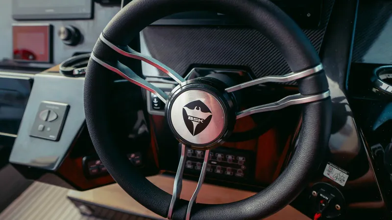 2023 Skipper-bsk 42 Quad 450r Yacht Photos Pics Steering wheel of 2023 Skipper-BSK 42 boat, featuring modern dashboard controls.