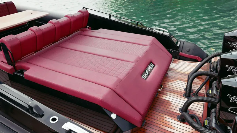 2023 Skipper-bsk 42 Quad 450r Yacht Photos Pics Luxurious Skipper-BSK 42 boat with red seating, 2023 model, docked on wooden deck.