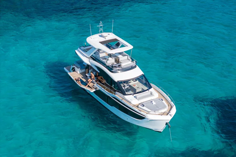  Yacht Photos Pics 2026 Galeon 560 Fly yacht on clear turquoise water, showcasing luxury and modern design.