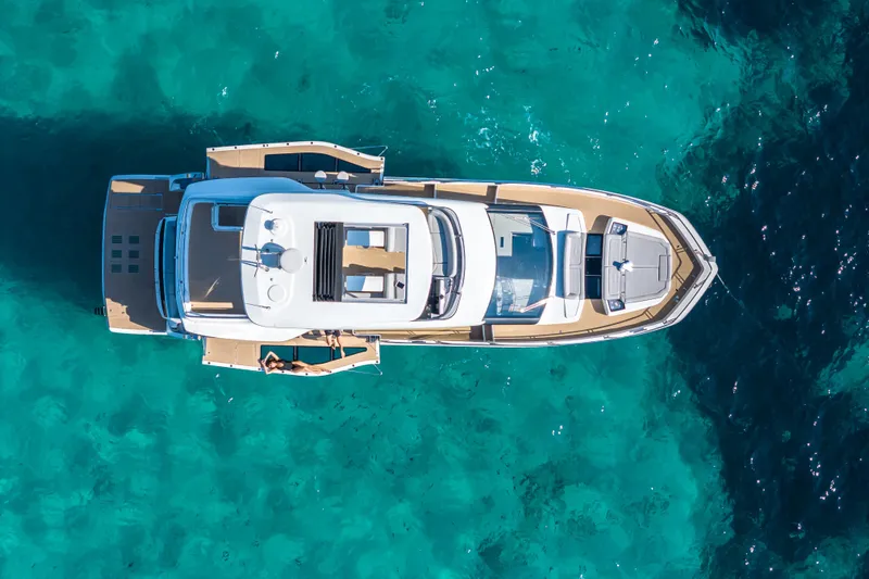  Yacht Photos Pics Aerial view of 2026 Galeon 560 Fly yacht on turquoise water.