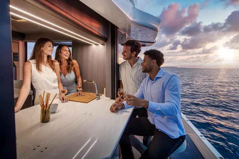  Yacht Photos Pics People enjoying drinks on a 2026 Galeon 560 Fly yacht at sunset.