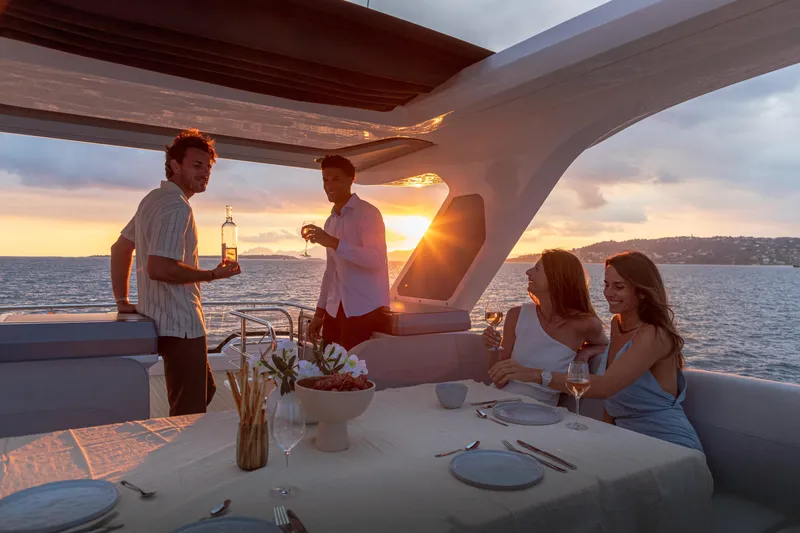  Yacht Photos Pics 2026 Galeon 560 Fly yacht with people enjoying sunset dining on deck.