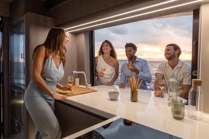  Yacht Photos Pics People enjoying drinks on a 2026 Galeon 560 Fly yacht at sunset.