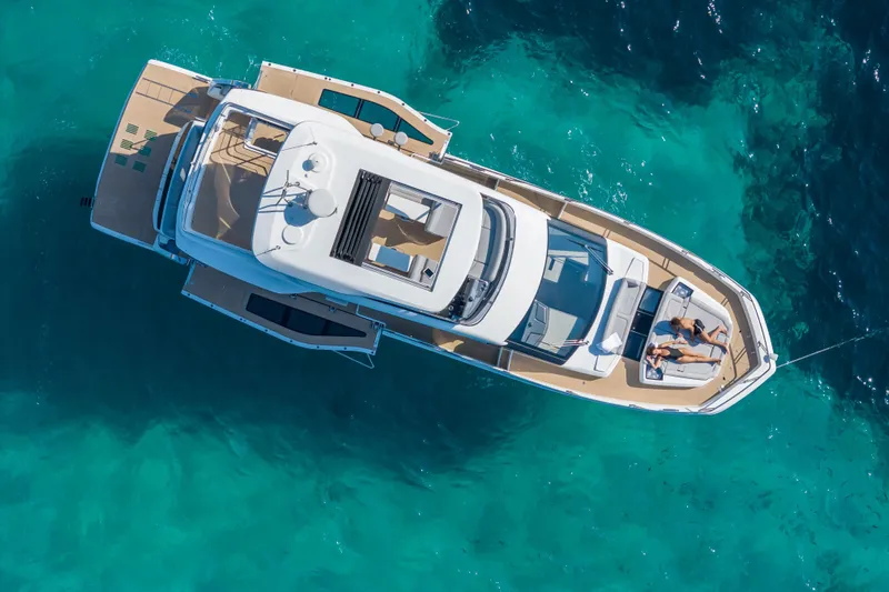  Yacht Photos Pics Aerial view of 2026 Galeon 560 Fly yacht on clear turquoise water.