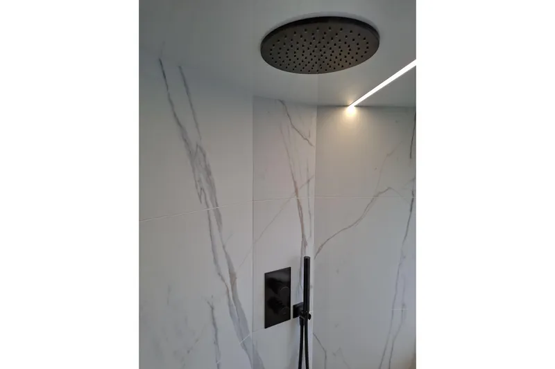  Yacht Photos Pics Luxurious shower in 2026 Galeon 560 Fly yacht with modern fixtures and marble walls.