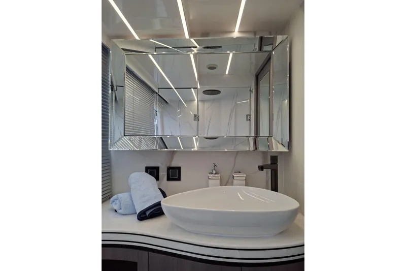  Yacht Photos Pics Luxurious bathroom interior of 2026 Galeon 560 Fly yacht with modern sink and mirror.