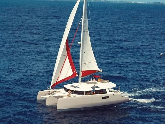  Yacht Photos Pics Trimaran sailing on open sea, NEEL 51 model, 2017, with white and red sails.
