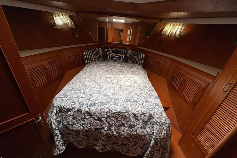 Majestic Z Yacht Photos Pics Luxurious 1990 Angel Pilothouse cabin interior with cozy bed and elegant wood finish.