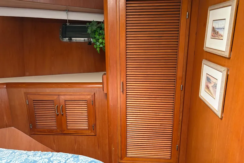 Majestic Z Yacht Photos Pics Interior of 1990 Angel Pilothouse with wooden cabinets and framed artwork.