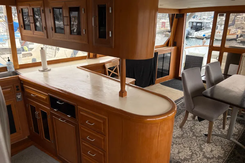 Majestic Z Yacht Photos Pics Interior of 1990 Angel Pilothouse yacht with wooden cabinetry and dining area.