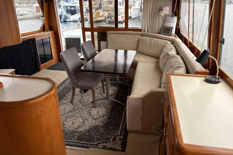 Majestic Z Yacht Photos Pics Luxurious 1990 Angel Pilothouse interior with elegant seating and dining area, overlooking marina.