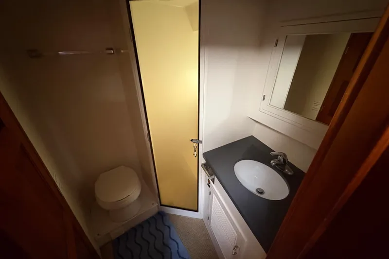 Majestic Z Yacht Photos Pics Compact bathroom in 1990 Angel Pilothouse with sink, toilet, and shower.