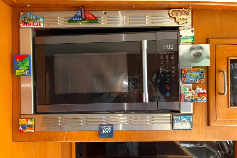 Majestic Z Yacht Photos Pics Microwave with travel magnets on a 1990 Angel Pilothouse boat.