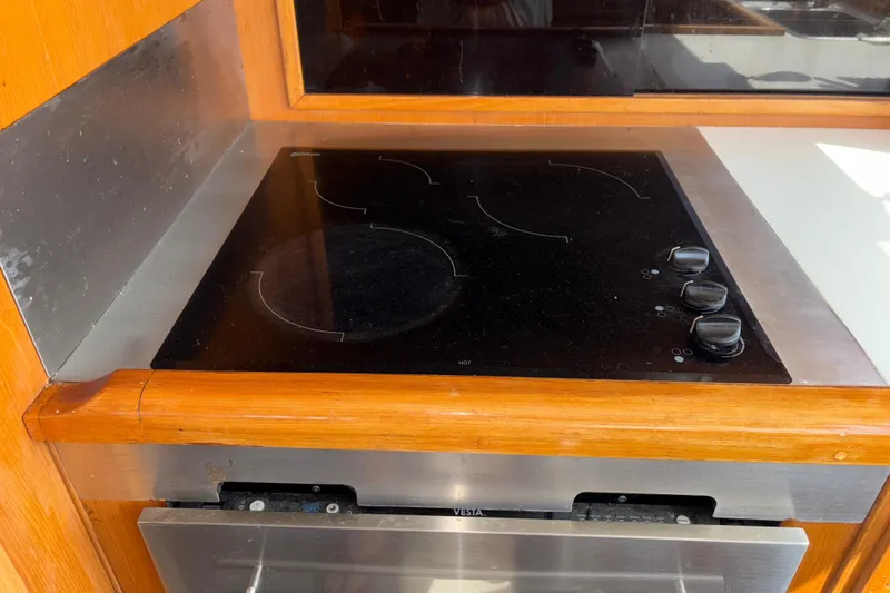 Majestic Z Yacht Photos Pics Electric stove in 1990 Angel Pilothouse kitchen with wooden trim.