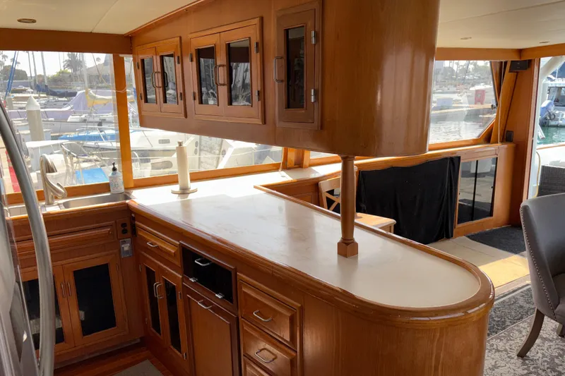 Majestic Z Yacht Photos Pics Luxurious 1990 Angel Pilothouse yacht interior with wooden cabinetry and marina view.