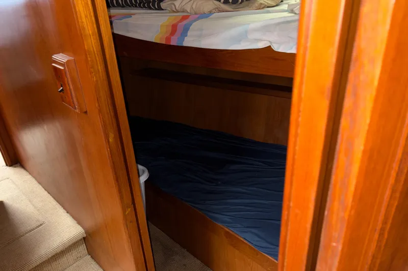 Majestic Z Yacht Photos Pics Cozy wooden bunk beds inside a 1990 Angel Pilothouse boat cabin.
