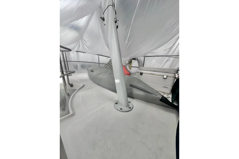 Ohana Yacht Photos Pics 1999 Mainship 390 Trawler deck under protective cover, featuring railings and storage.