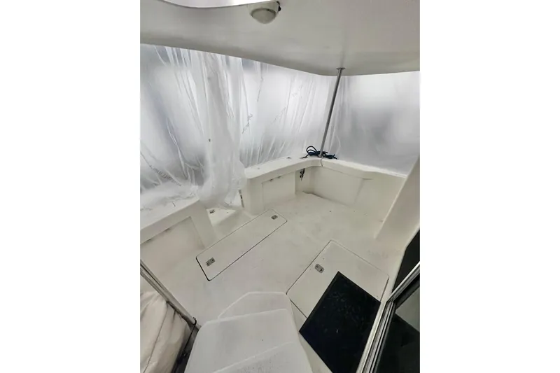 Ohana Yacht Photos Pics 1999 Mainship 390 Trawler interior with white seating and storage compartments.