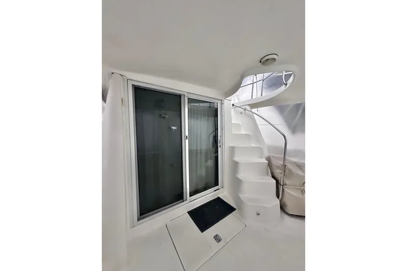 Ohana Yacht Photos Pics 1999 Mainship 390 Trawler interior with spiral staircase and sliding glass door.