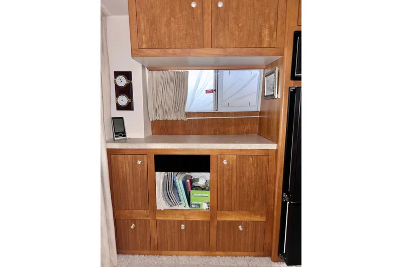 Ohana Yacht Photos Pics 1999 Mainship 390 Trawler interior with wooden cabinets and nautical decor.