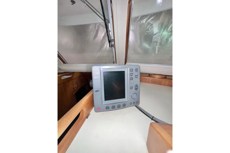 Ohana Yacht Photos Pics 1999 Mainship 390 Trawler helm with navigation equipment and wooden interior details.