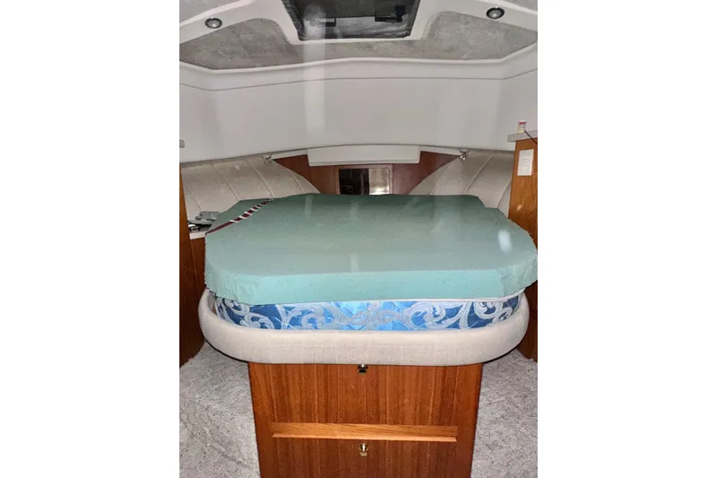 Ohana Yacht Photos Pics 1999 Mainship 390 Trawler cabin interior with bed and wooden cabinetry.