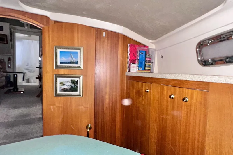 Ohana Yacht Photos Pics Interior of 1999 Mainship 390 Trawler with wooden cabinetry and framed nautical photos.