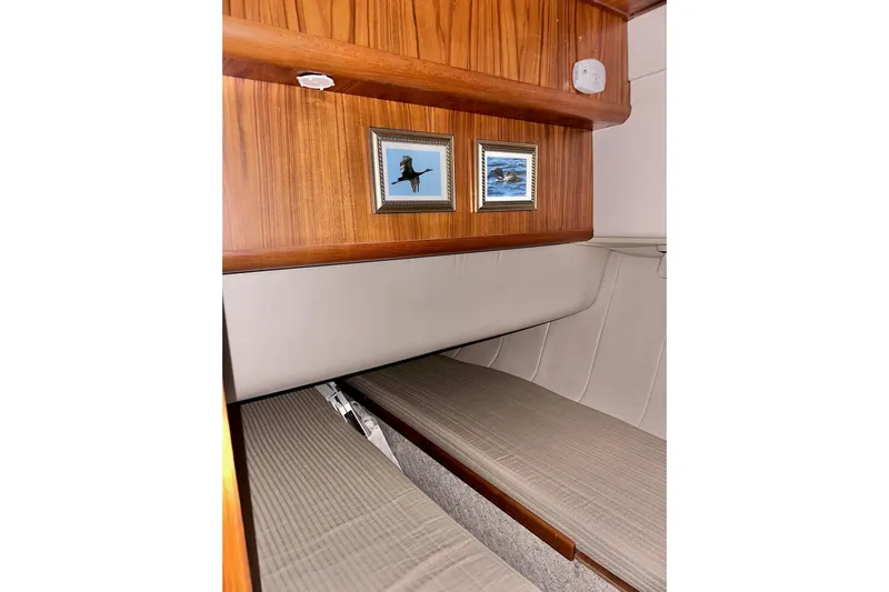 Ohana Yacht Photos Pics 1999 Mainship 390 Trawler interior with framed pictures and wooden paneling.