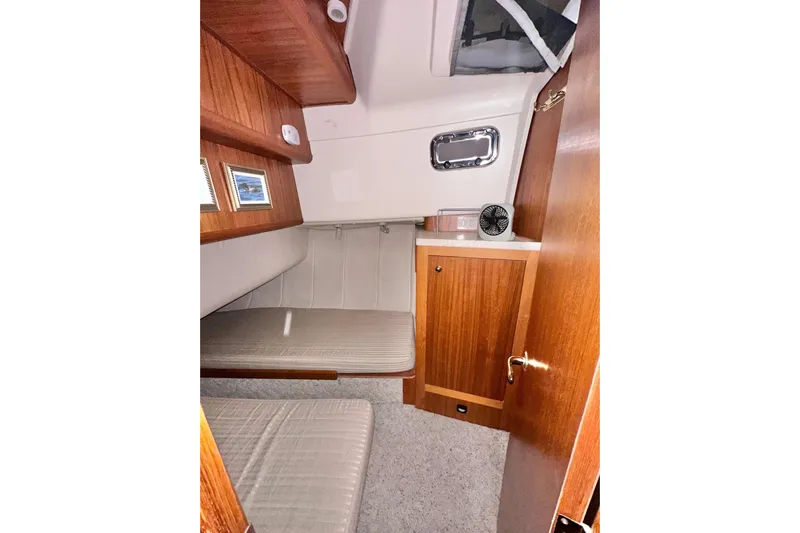 Ohana Yacht Photos Pics 1999 Mainship 390 Trawler cabin interior with wood paneling and cozy seating.