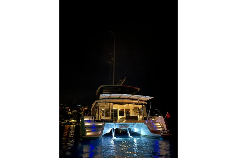 Chicago Yacht Photos Pics 2020 Lagoon 52 F catamaran illuminated at night on the water.