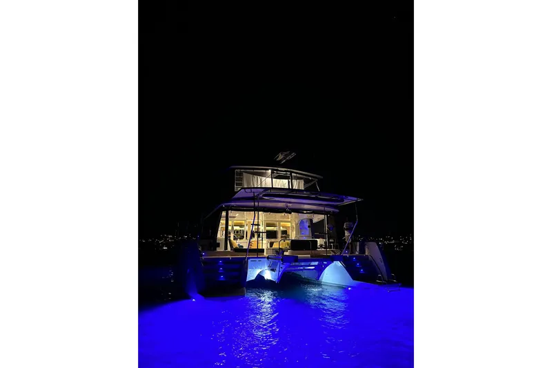 Chicago Yacht Photos Pics Lagoon 52 F 2020 yacht illuminated at night with blue underwater lights.