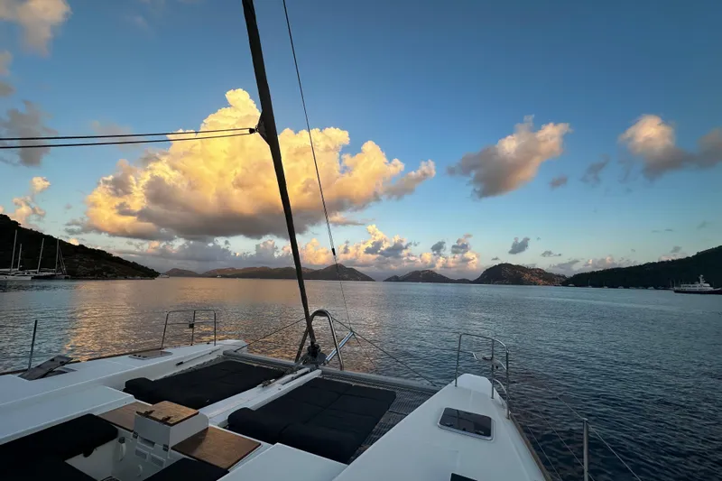 Chicago Yacht Photos Pics Lagoon 52 F yacht at sunset, 2020 model, with scenic ocean and cloud view.