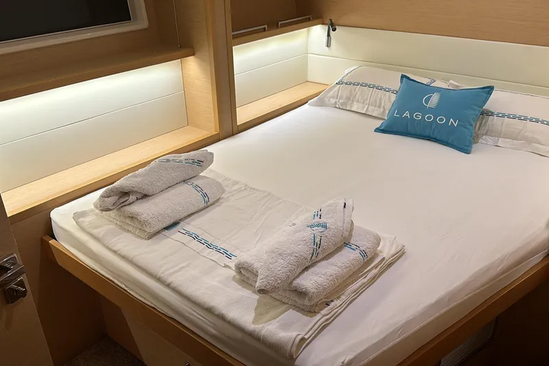 Chicago Yacht Photos Pics Luxurious cabin interior of 2020 Lagoon 52 F yacht with neatly arranged bed and towels.