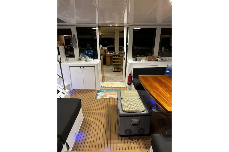 Chicago Yacht Photos Pics Interior of 2020 Lagoon 52 F yacht with wooden flooring and modern seating area.