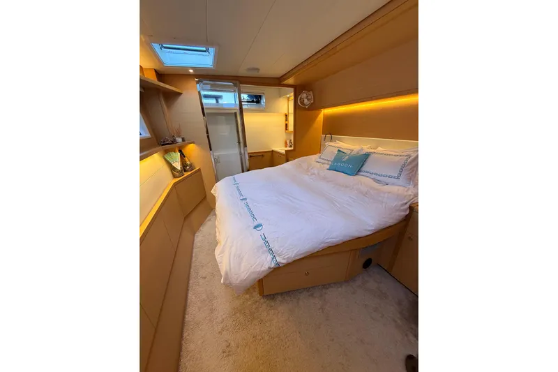 Chicago Yacht Photos Pics Luxurious bedroom interior of 2020 Lagoon 52 F yacht with modern design and cozy lighting.