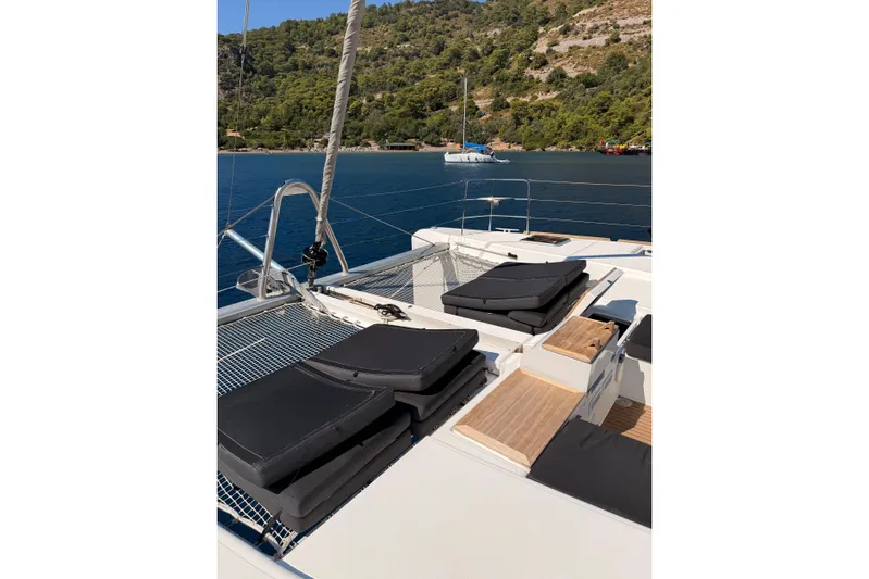 Chicago Yacht Photos Pics 2020 Lagoon 52 F catamaran deck with sun loungers, moored in scenic bay.