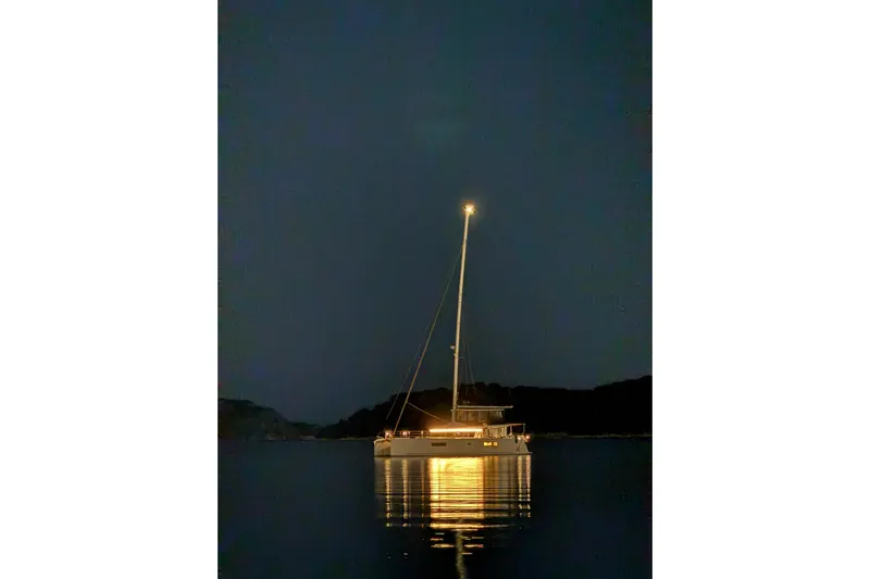 Chicago Yacht Photos Pics Lagoon 52 F 2020 catamaran illuminated at night on calm water.