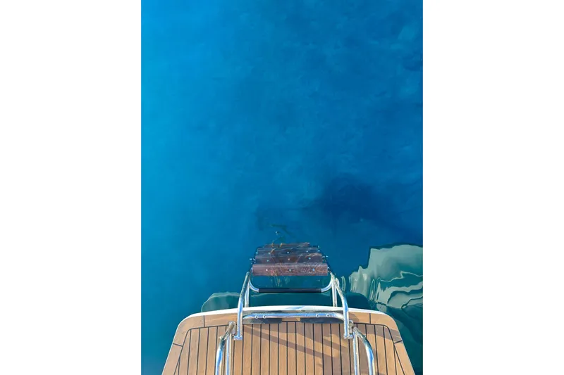 Chicago Yacht Photos Pics Lagoon 52 F yacht's swim platform and ladder over clear blue water, 2020 model.