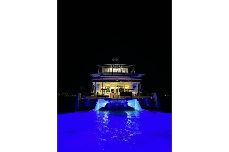 Chicago Yacht Photos Pics Lagoon 52 F 2020 yacht illuminated at night with vibrant blue underwater lights.