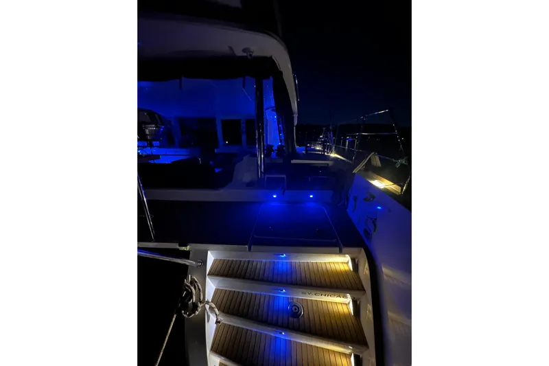 Chicago Yacht Photos Pics 2020 Lagoon 52 F yacht illuminated at night with blue and yellow lights.