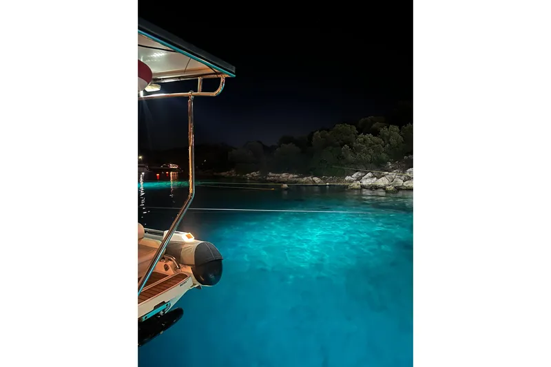 Chicago Yacht Photos Pics Night view from Lagoon 52 F yacht, 2020 model, overlooking illuminated turquoise waters.