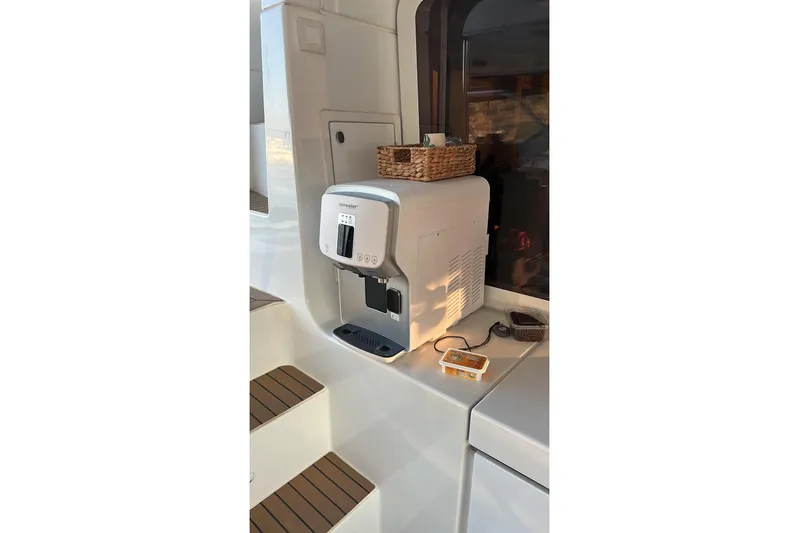 Chicago Yacht Photos Pics Coffee machine on Lagoon 52 F yacht, 2020 model, with wooden steps and countertop accessories.