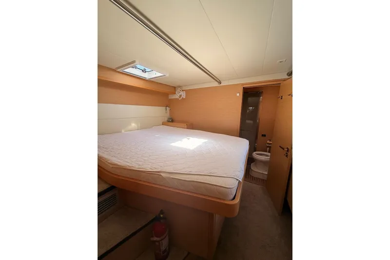 Chicago Yacht Photos Pics Luxurious cabin interior of 2020 Lagoon 52 F yacht with bed and ensuite bathroom.