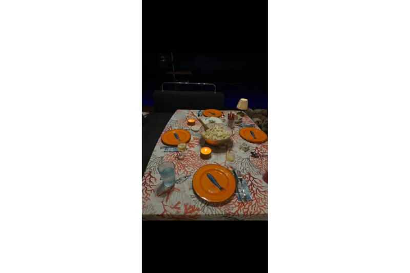 Chicago Yacht Photos Pics Dining table set with orange plates and candles on Lagoon 52 F yacht.