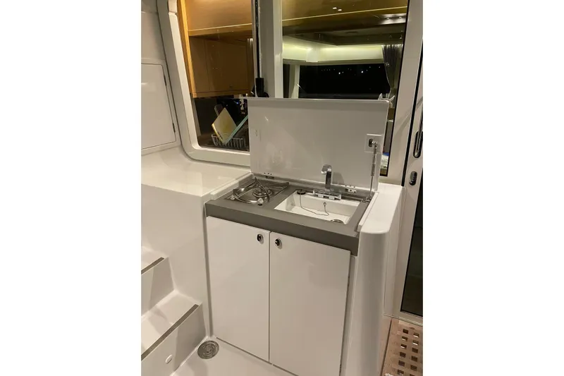 Chicago Yacht Photos Pics Compact kitchen area on a 2020 Lagoon 52 F yacht, featuring a sink and stove.