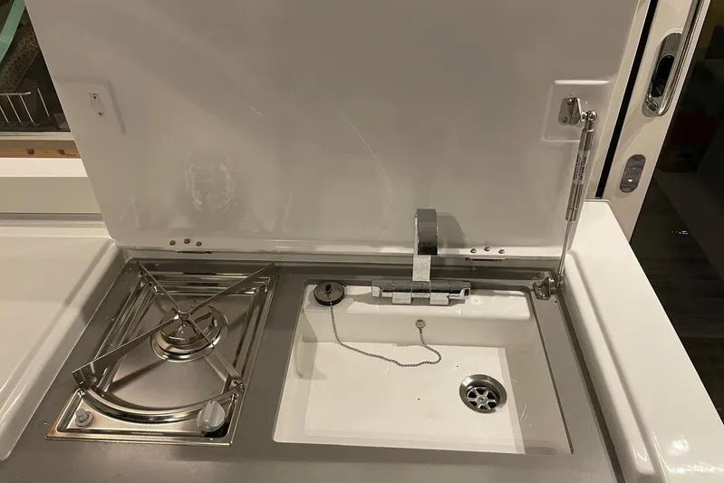 Chicago Yacht Photos Pics Compact kitchen area on a 2020 Lagoon 52 F yacht with stove and sink.