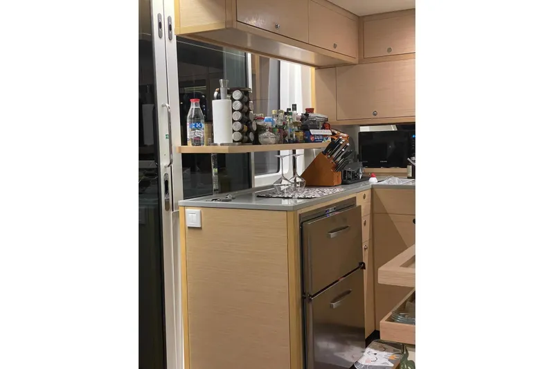 Chicago Yacht Photos Pics Modern kitchen interior on 2020 Lagoon 52 F yacht, featuring sleek cabinetry and appliances.