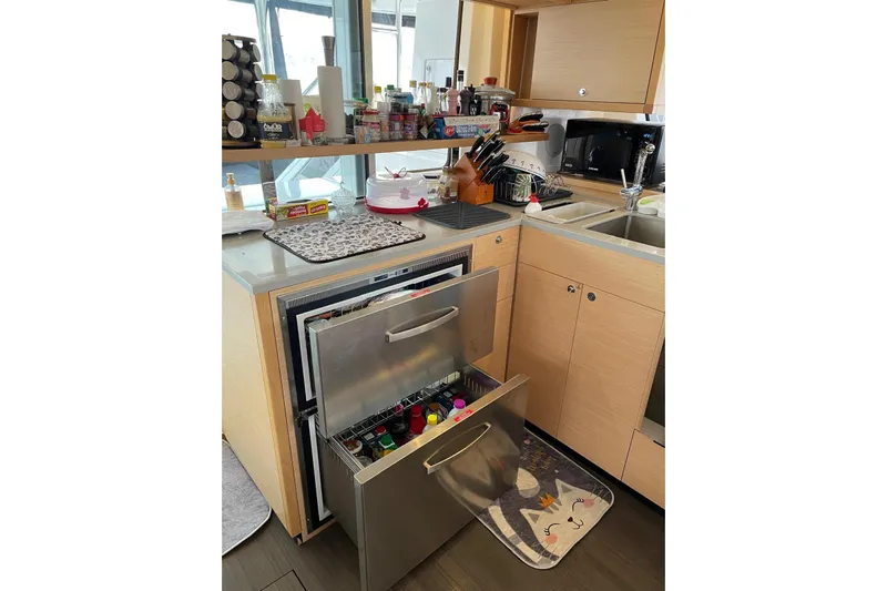 Chicago Yacht Photos Pics Modern kitchen on a 2020 Lagoon 52 F yacht with open drawers and organized countertop.